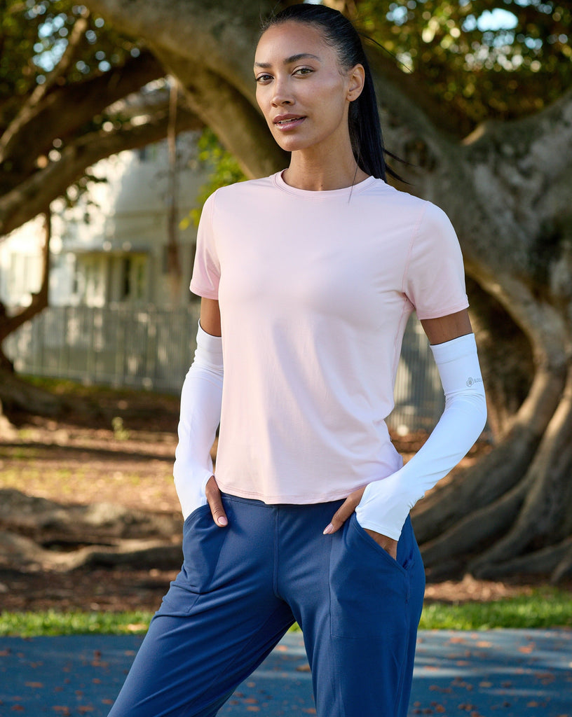 Women wearing tickle me pink short sleeve crew top with white sun sleeves and navy joggers. (Style 1101) - BloqUV