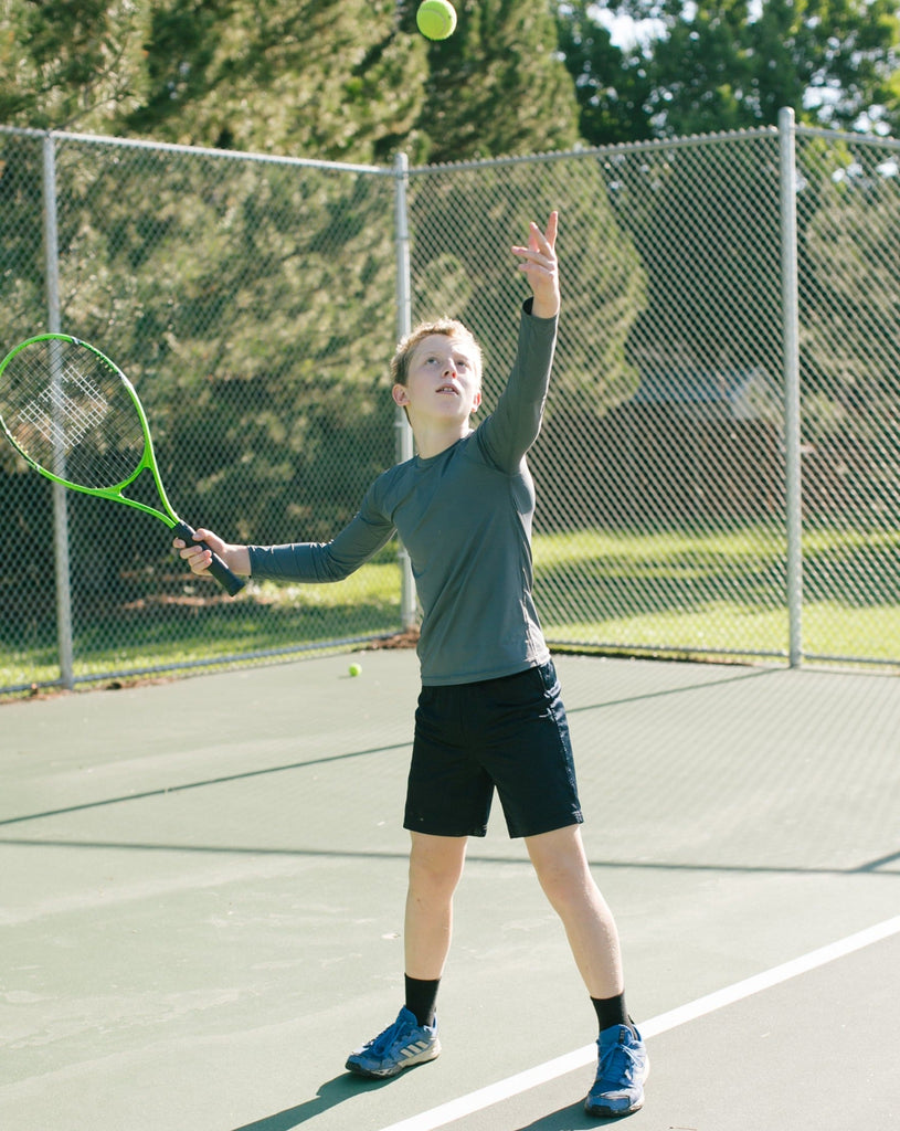 Boy playing tennis wearing smoke color top. (Style 1005K) - BloqUV