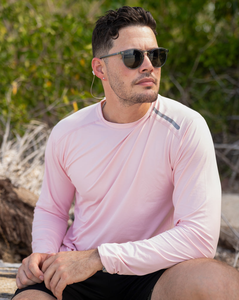 Man sitting wearing long sleeve jet tee shirt in tickle me pink. (Style 12002) - BloqUV