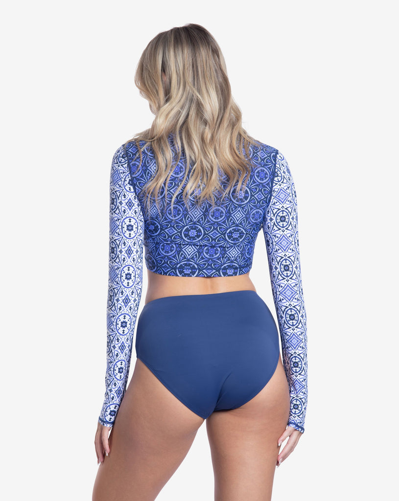 Women wearing printed top with Moroccan Tile navy print long sleeve 24/7 shirt with navy swimsuit bottom. Picture shows the back of shirt. (Style 4015J) - BloqUV