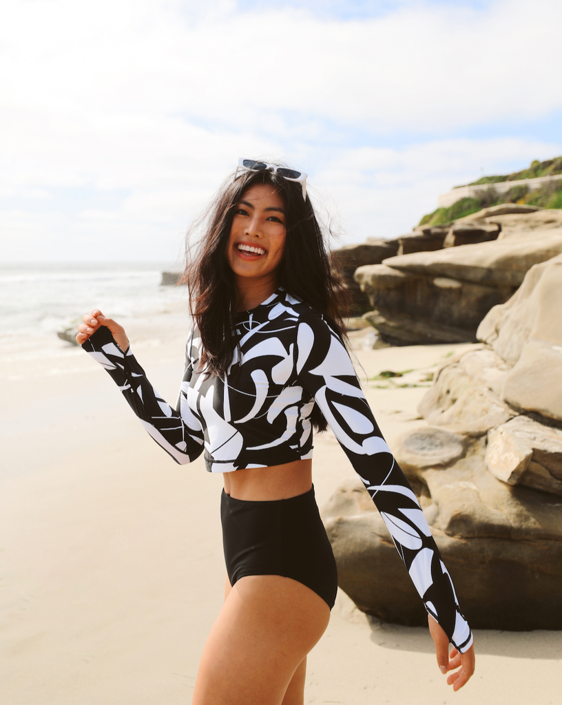 Women at the beach wearing printed black and white long sleeve everyday crop top with black swimsuit bottom. (Style 4015J) - BloqUV