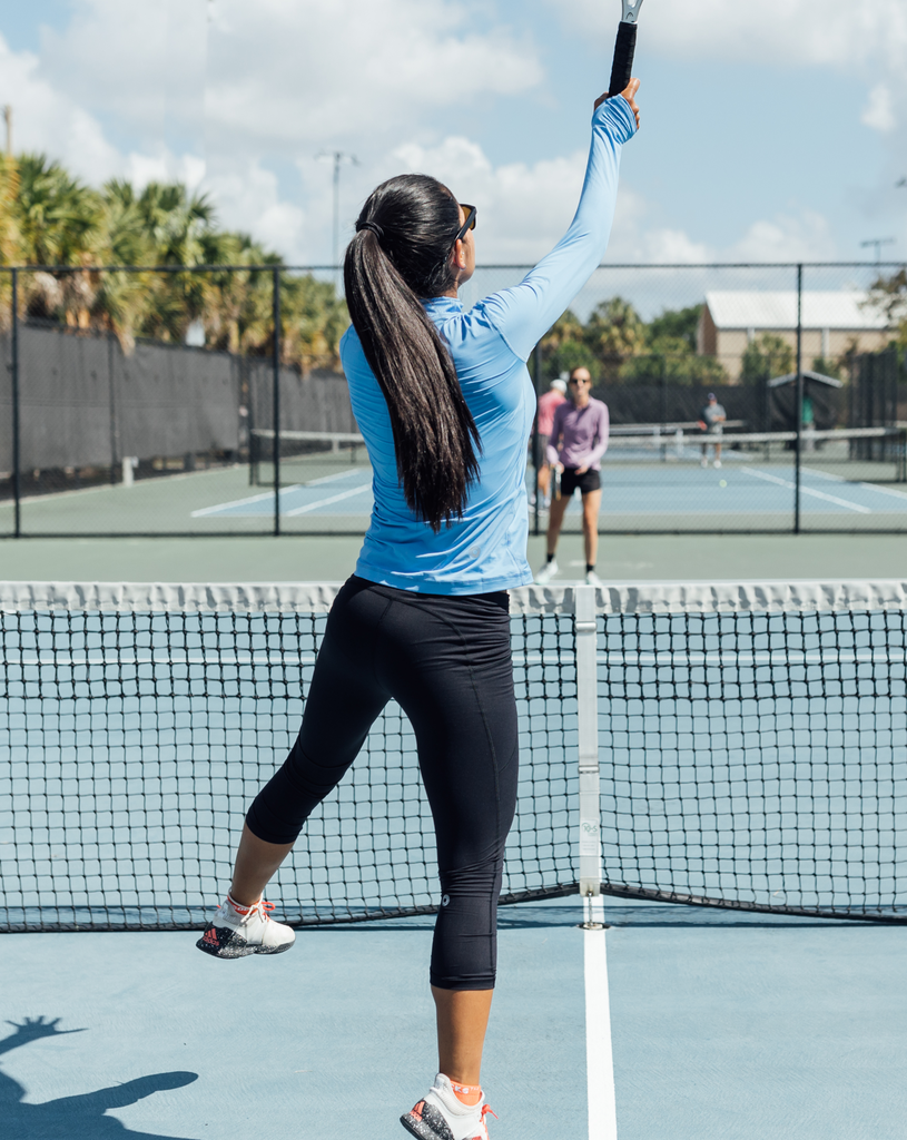 Women playing tennis wearing compression capri leggings in black. (Style 6103) -BloqUV