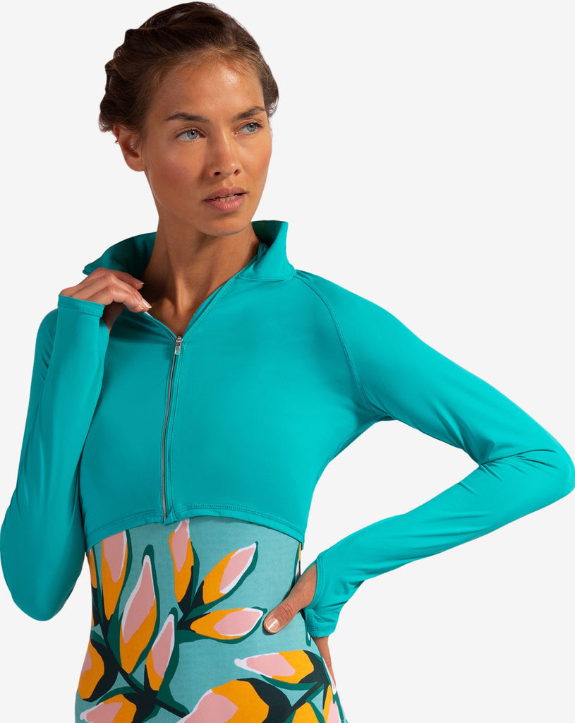 Women wearing caribbean blue full zip crop top over printed swimsuit. (Style 4010) - BloqUV