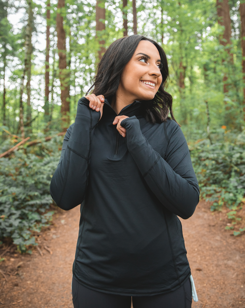 Women walking outdoors surrounded by trees wearing black relaxed mock zip top.  (Style 3002) - BloqUV