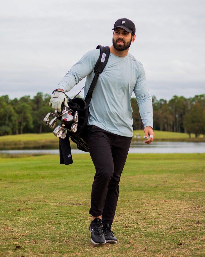 Man walking golf course wearing long sleeve jet tee shirt in soft grey. (Style 12002) - BloqUV