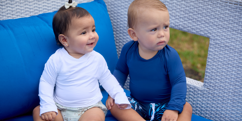 A toddler in the pool, wearing a UV protection swim shirt