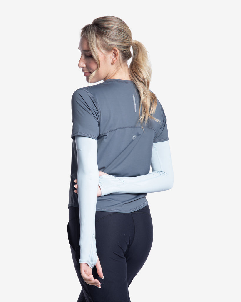Women wearing smoke short sleeve crew top with soft grey sun sleeves and black joggers tights. Picture shows reflector on the back of the shirt. (Style 1101) - BloqUV