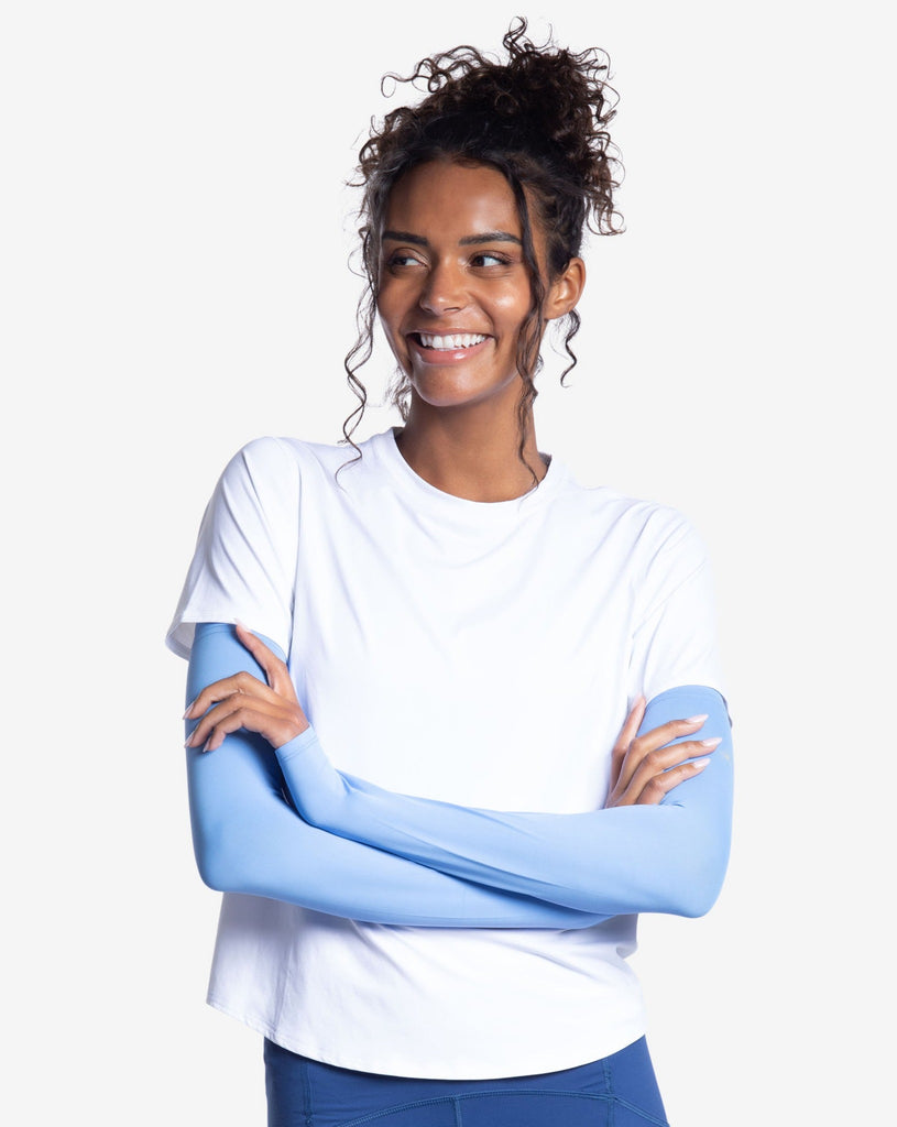 Women wearing white short sleeve crew top with indigo sun sleeves and navy tights. (Style 1101) - BloqUV