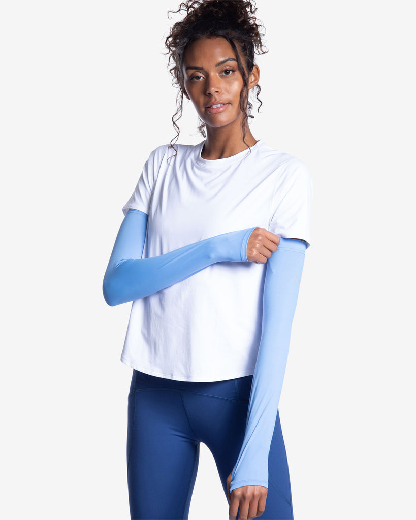 Women wearing white short sleeve crew top with indigo sun sleeves and navy tights. (Style 1101) - BloqUV