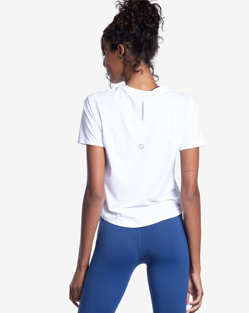 Women wearing white short sleeve crew top with and navy tights. Picture shows back of shirt with reflector. (Style 1101) - BloqUV