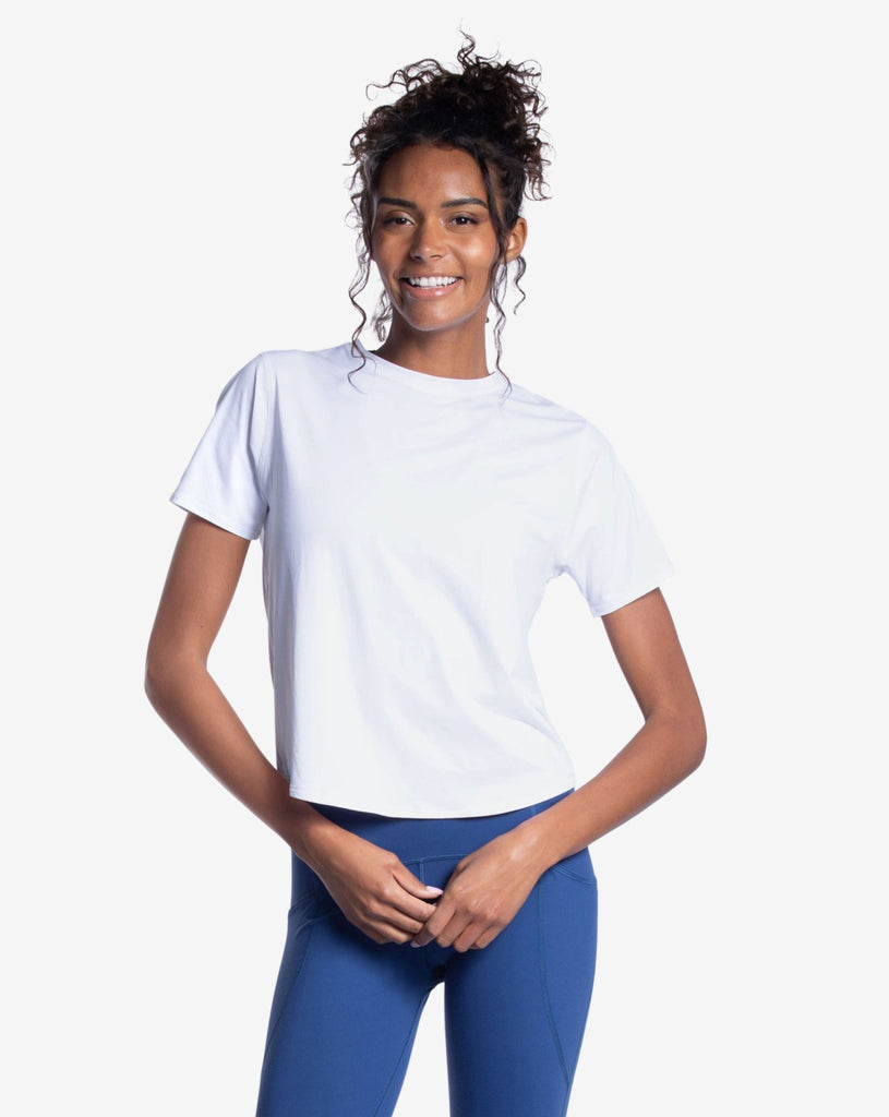 Women wearing white short sleeve crew top with and navy tights. (Style 1101) - BloqUV