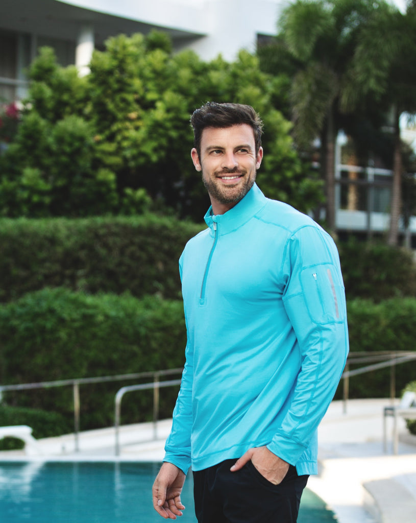 Man outdoors wearing long sleeve mock zip shirt in Light turquoise. (Style 12001) - BloqUV