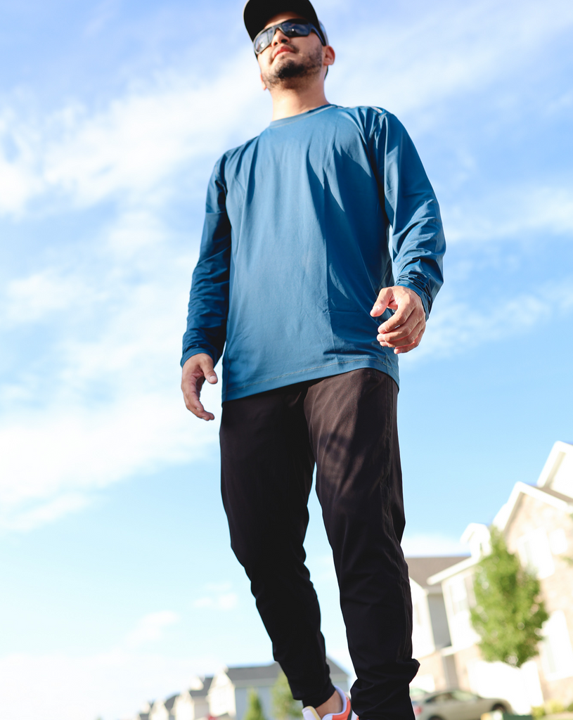 Man standing outside in neighborhood wearing long sleeve jet tee shirt in midnight blue. (Style 12002) - BloqUV