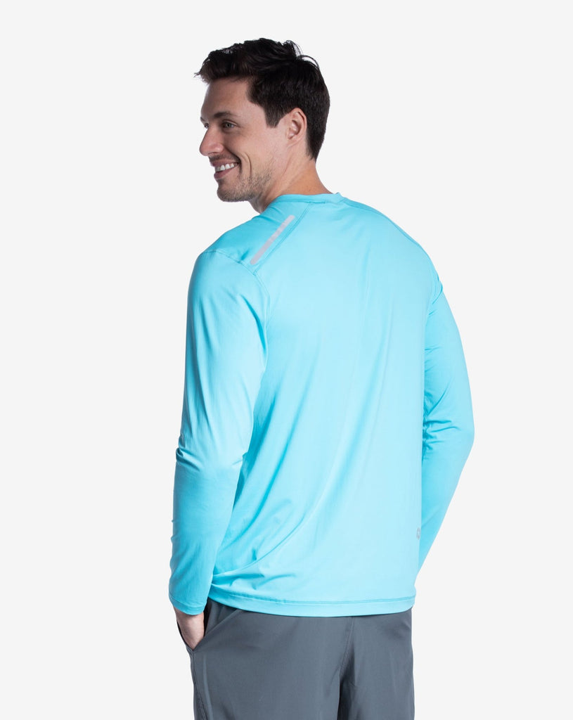 Man wearing long sleeve jet tee shirt in light turquoise - side view. (Style 12002) - BloqUV