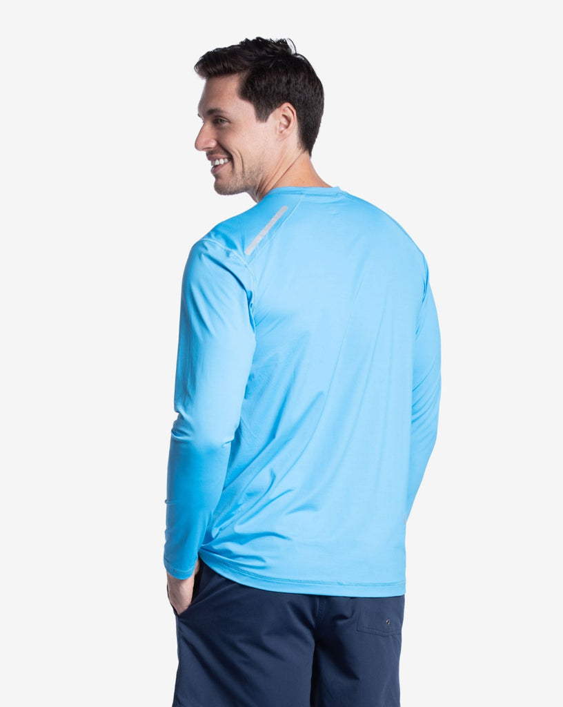 Man wearing long sleeve jet tee shirt in ocean blue. Picture shows the back of the shirt. (Style 12002) - BloqUV