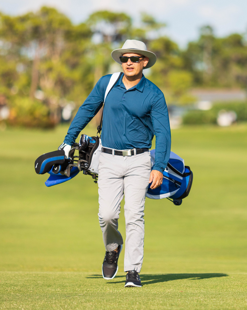 Man wearing long sleeve collared shirt in navy blue playing golf. (Style 12004) - BloqUV