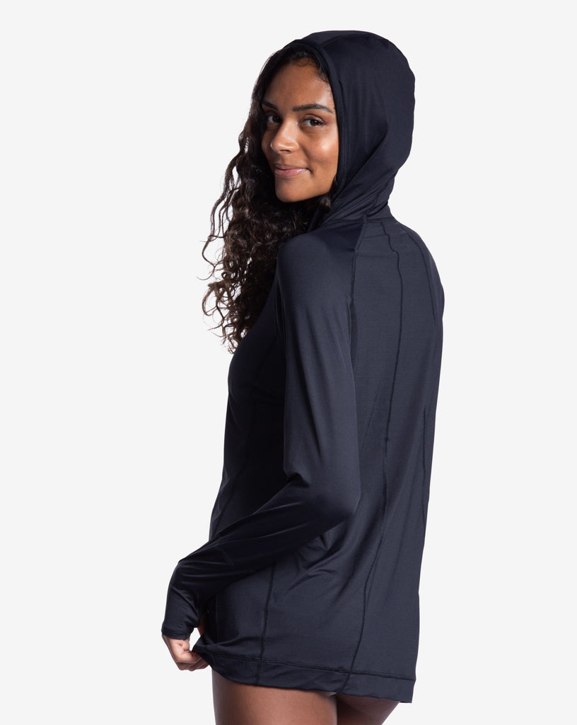 Women wearing black color unisex long sleeve hoodie shirt. Picture shows hoodie covering the head. (Style 12007) - BloqUV