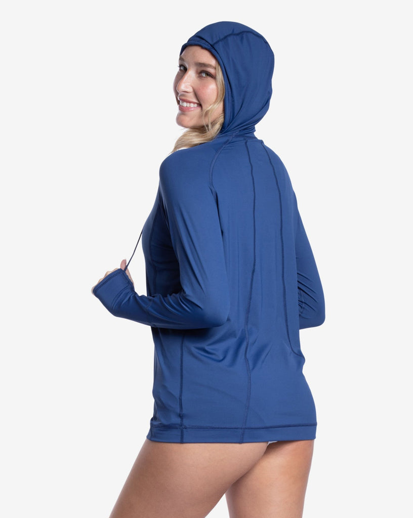 Women wearing navy color unisex long sleeve hoodie shirt. Picture shows hoodie over the head. (Style 12007) - BloqUV