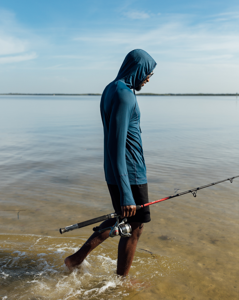 Man fishing wearing midnight blue color unisex long sleeve hoodie shirt. (Style 12007) - BloqUV