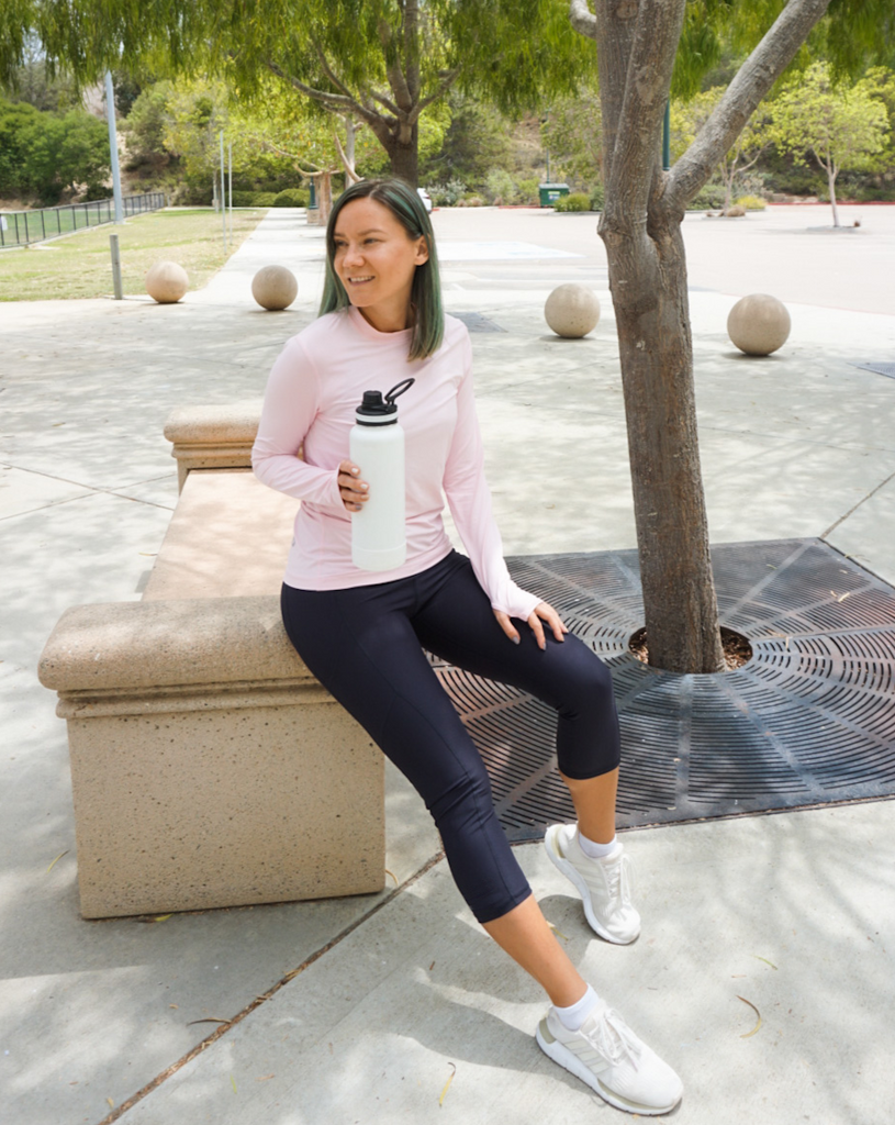 Women sitting on a bench at the park wearing tickle me pink long sleeve 24/7 shirt with leggings. (Style 2001) - BloqUV