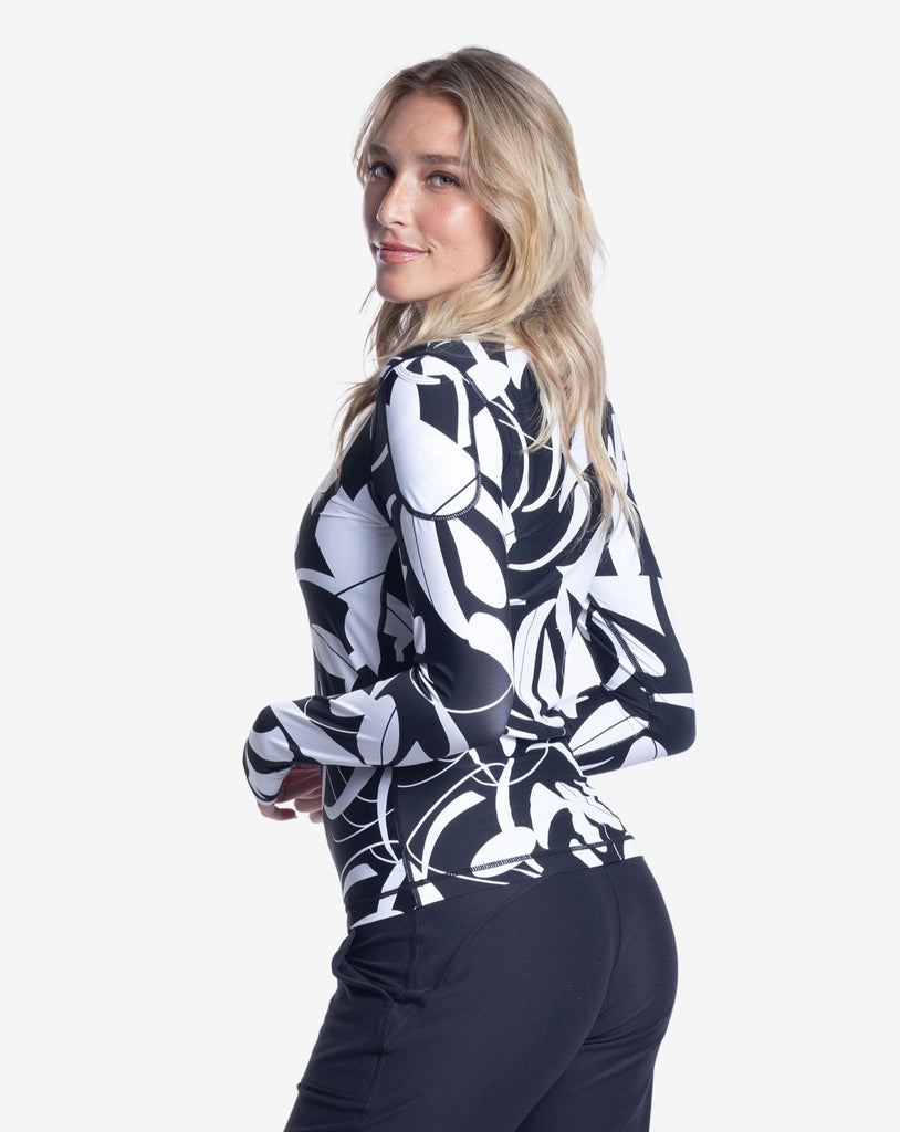 Women wearing printed black and white long sleeve 24/7 shirt with black joggers. Picture shows pocket on the sleeve. (Style 2001J) - BloqUV