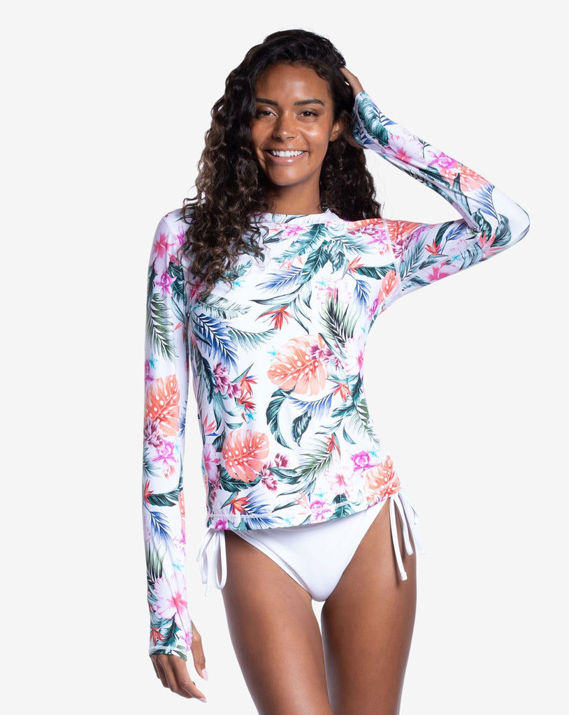 Women wearing printed white top with Hawaiian print long sleeve 24/7 shirt with white swimsuit bottom. (Style 2001J) - BloqUV