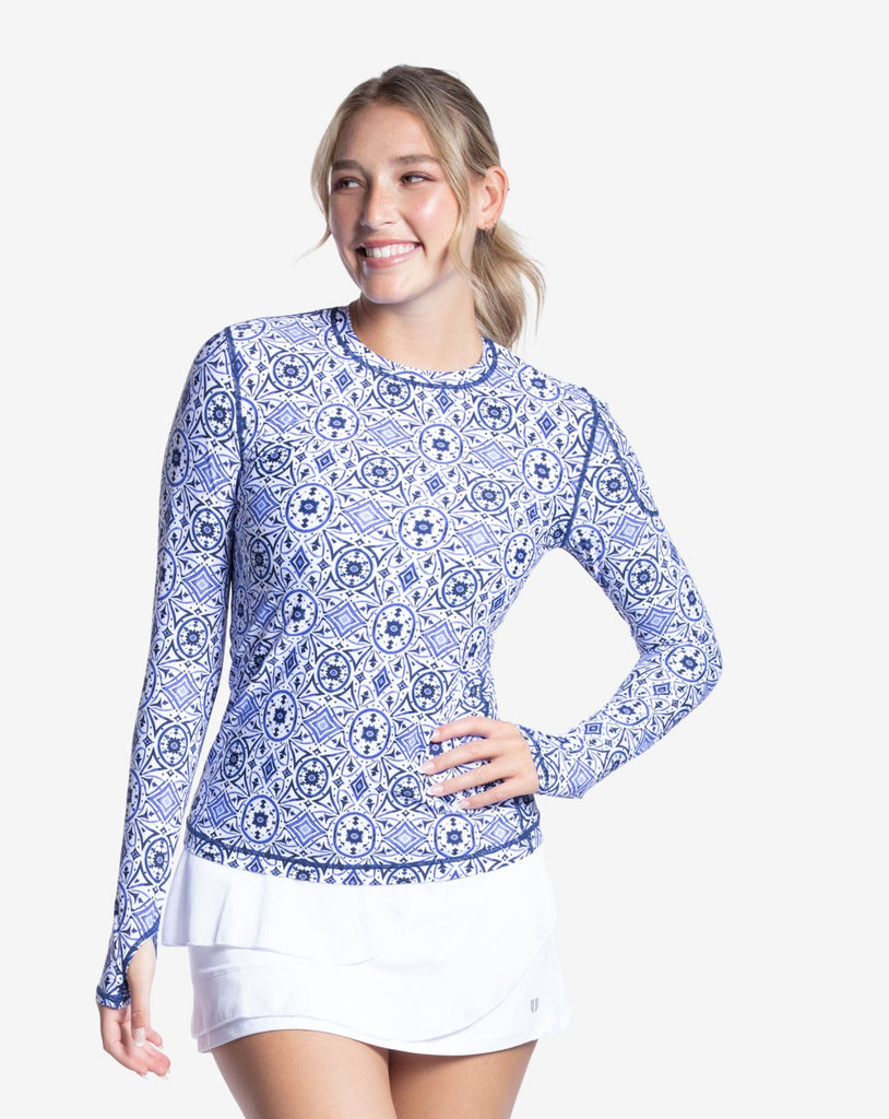 Women wearing printed top with Moroccan Tile navy print long sleeve 24/7 shirt with white skirt. (Style 2001J) - BloqUV