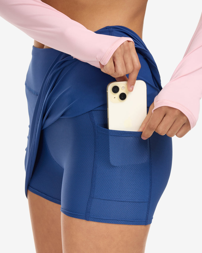 Women wearing navy skort showing cell phone inside pocket. (Style 6100) - BloqUV