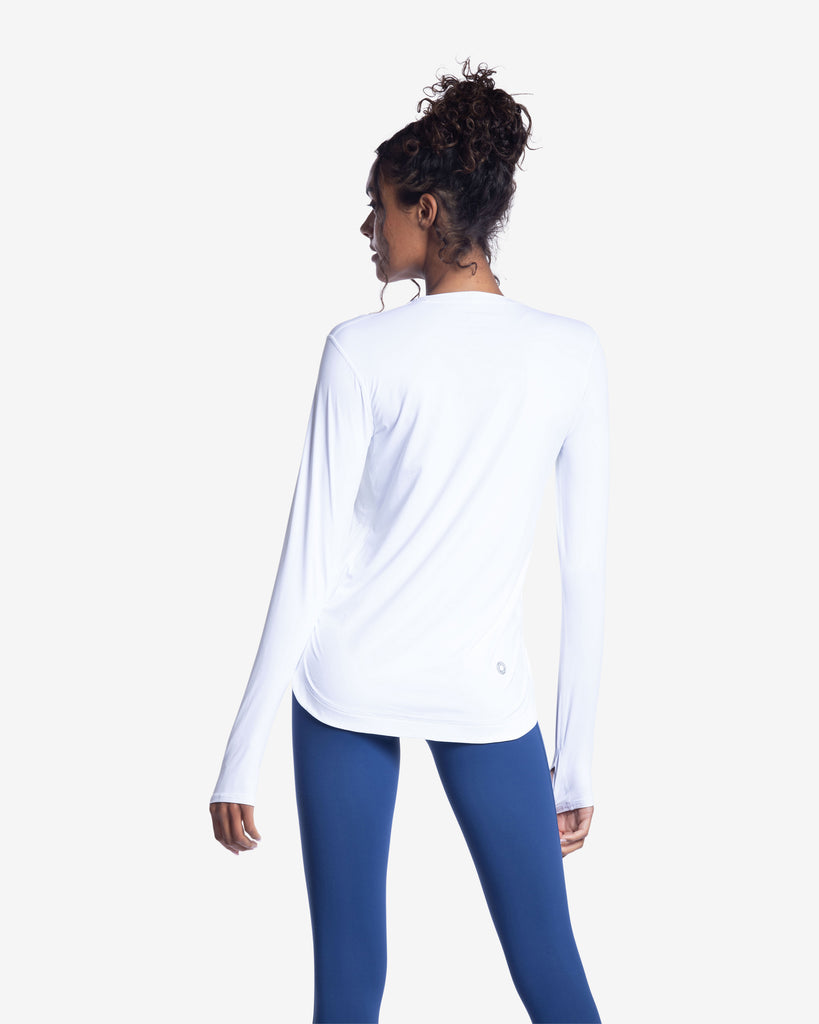 Women wearing white relaxed scallop top with navy tights. Picture shows back of shirt. (Style 2015) - BloqUV