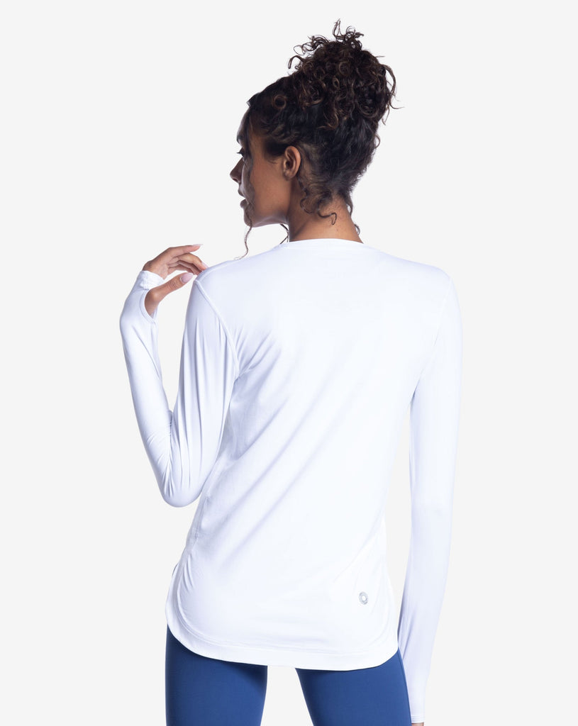 Women wearing white relaxed scallop top  with navy tights. Picture shows back of shirt. (Style 2015) - BloqUV