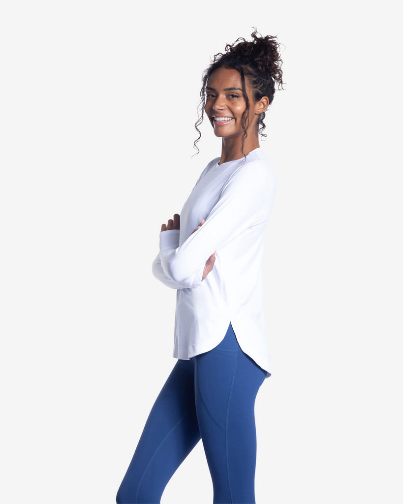 Women wearing white relaxed scallop top with navy tights. Picture shows side of shirt. (Style 2015) - BloqUV