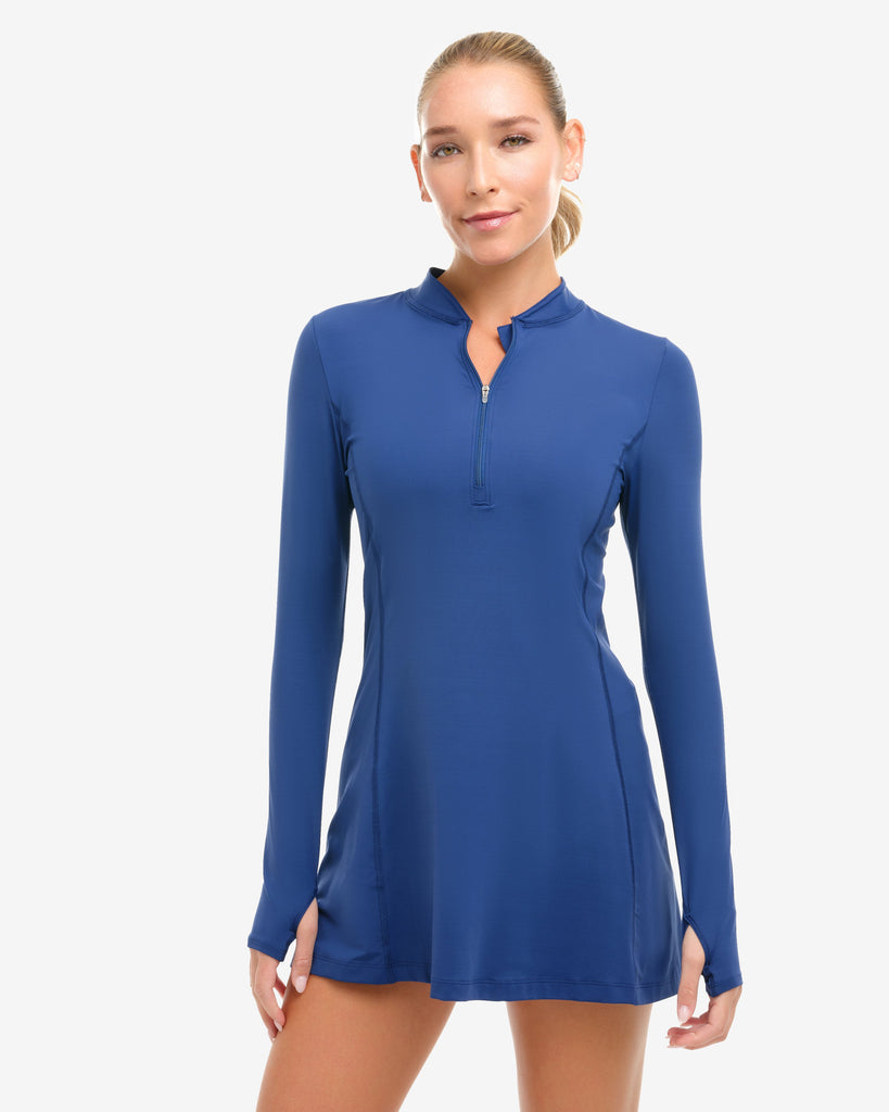 Woman wearing a blue long-sleeve dress on a white background