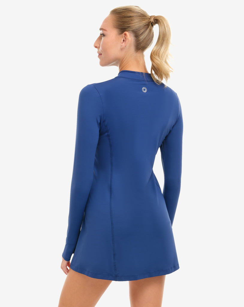 Woman wearing a blue long-sleeve dress on a white background