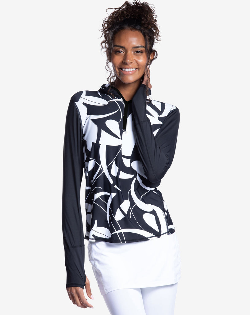 Women wearing printed black and white long sleeve relaxed mock zip with white capri skort. (Style 3002J) - BloqUV