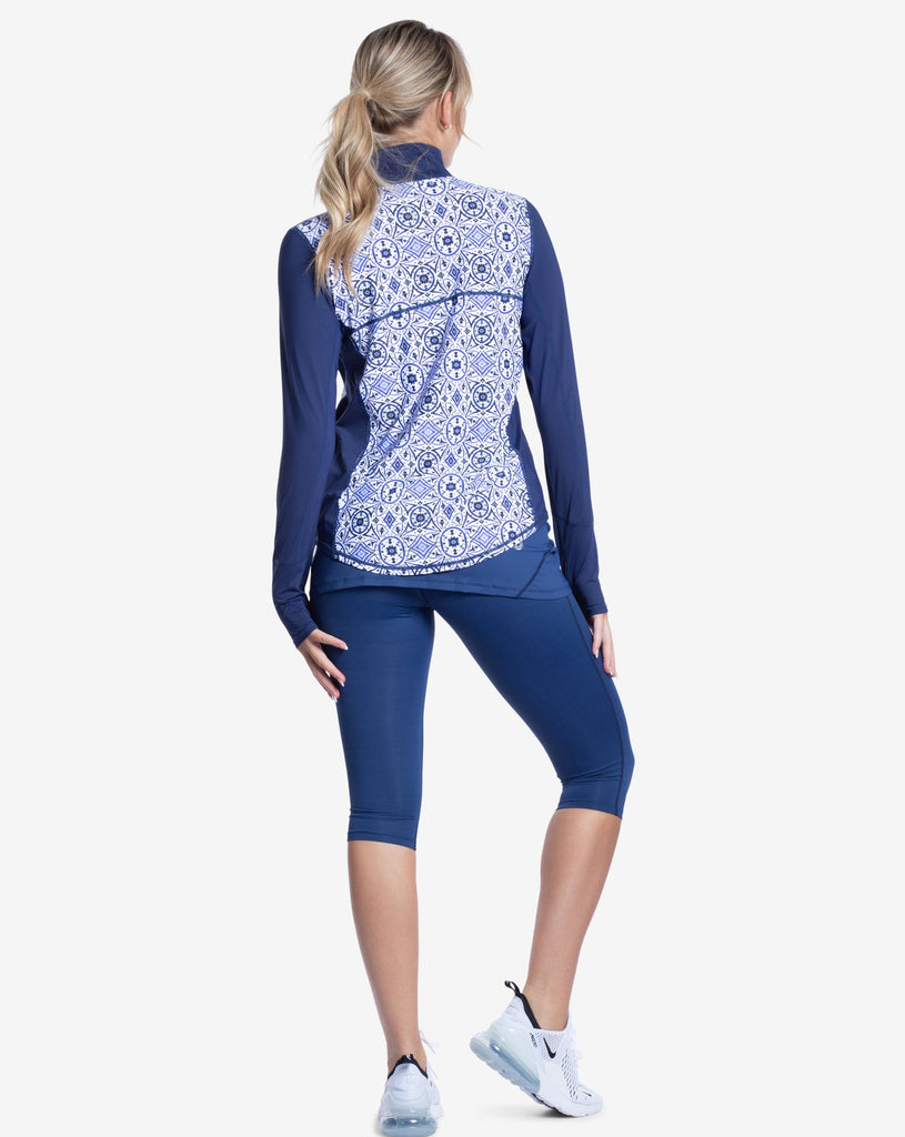 Women wearing printed top with Moroccan Tile navy print long sleeve relaxed mock zip top with navy skort. (Style 3002J) - BloqUV