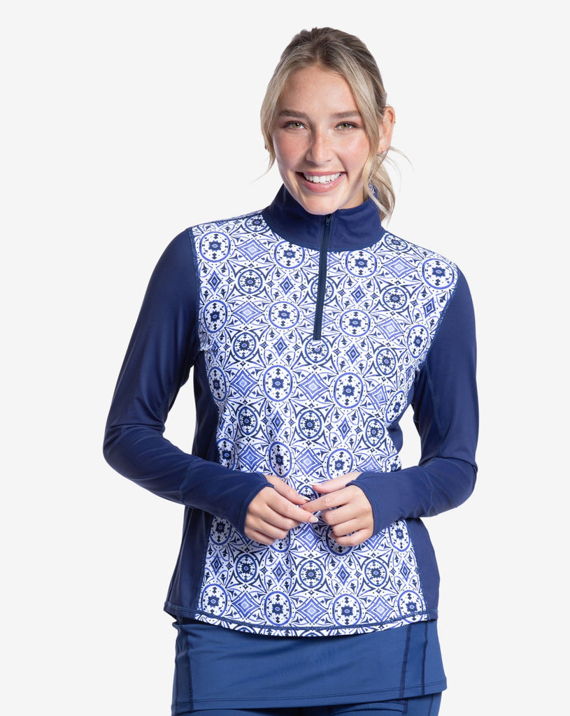 Women wearing printed top with Moroccan Tile navy print long sleeve relaxed mock zip top with navy skort. (Style 2001J) - BloqUV