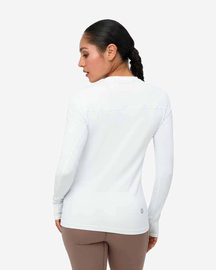 Woman wearing a white long-sleeve shirt on a white background