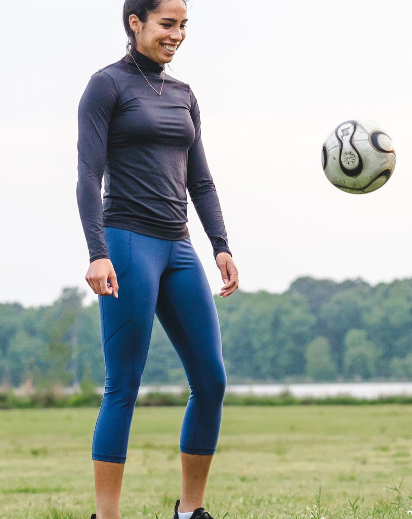 Women playing soccer wearing black turtle neck top with navy tights. (Style 2013) - BloqUV