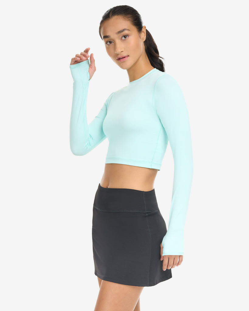 Women wearing everyday crop top in mint with black skort. (Style 6100) - BloqUV