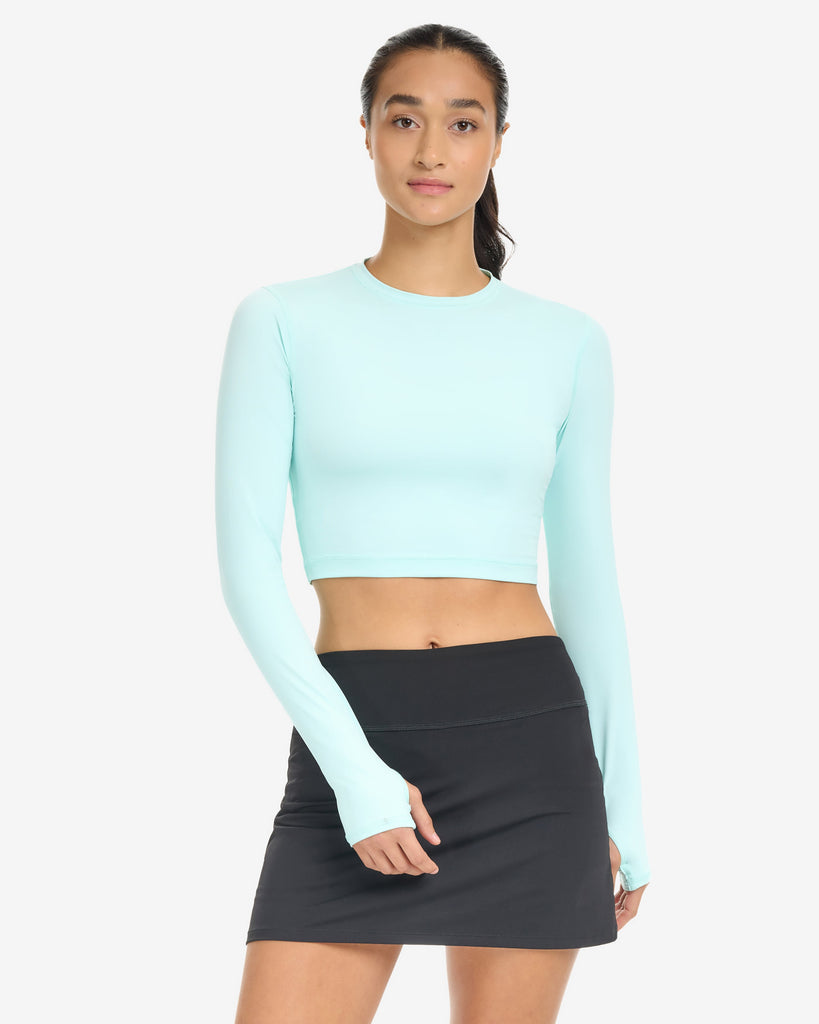 Women wearing everyday crop top in mint with black skort. (Style 6100) - BloqUV