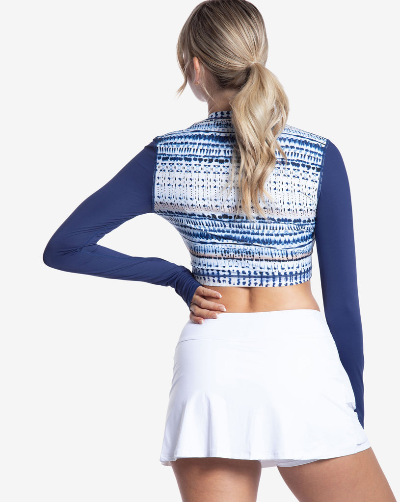 Women wearing printed top with water dunes print long sleeve everyday crop top with white skirt. Picture shows back of shirt. (Style 4015J) - BloqUV