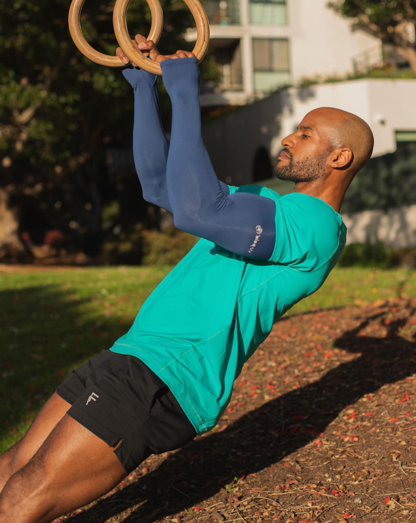 Man exercising outdoors wearing short sleeve crew shirt in caribbean blue with sun protective sleeves in navy. (Style 11002) - BloqUV