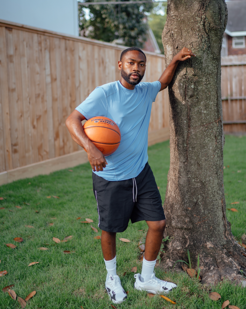 Man holding a basket ball wearing short sleeve crew shirt in indigo. (Style 11002) - BloqUV