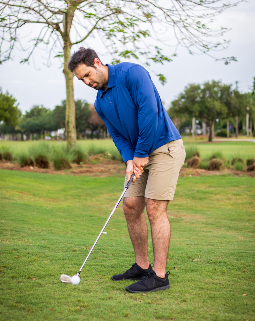 Man wearing long sleeve collared shirt in navy blue playing golf. (Style 12004) - BloqUV