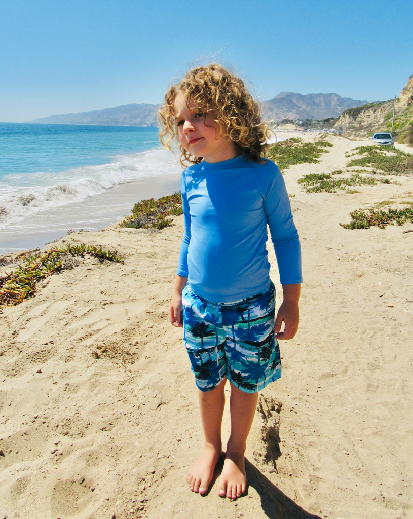 Boy at the beach wearing indigo blue color top over a swimsuit. (Style 1005K) - BloqUV