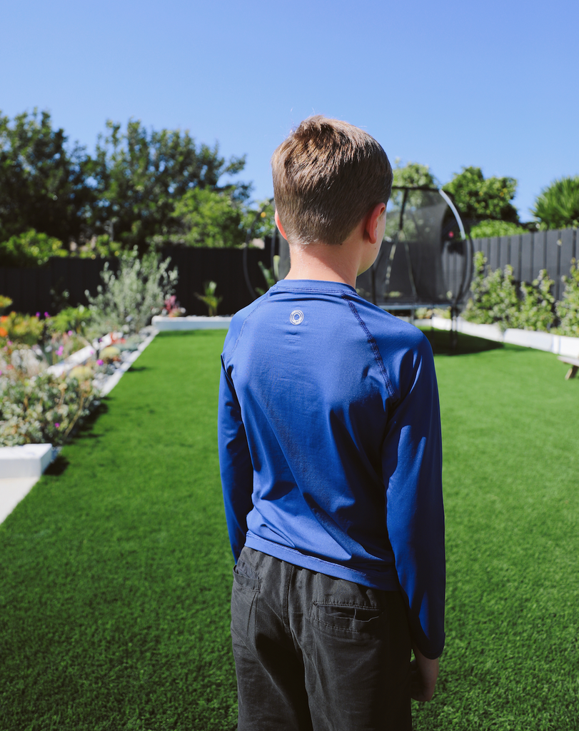 Boy wearing navy color top in backyard. (Style 1005K) - BloqUV