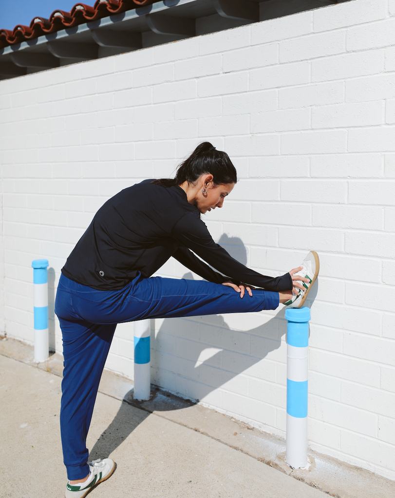 Women stretching wearing smoke long sleeve 24/7 shirt with navy joggers. (Style 2001) - BloqUV