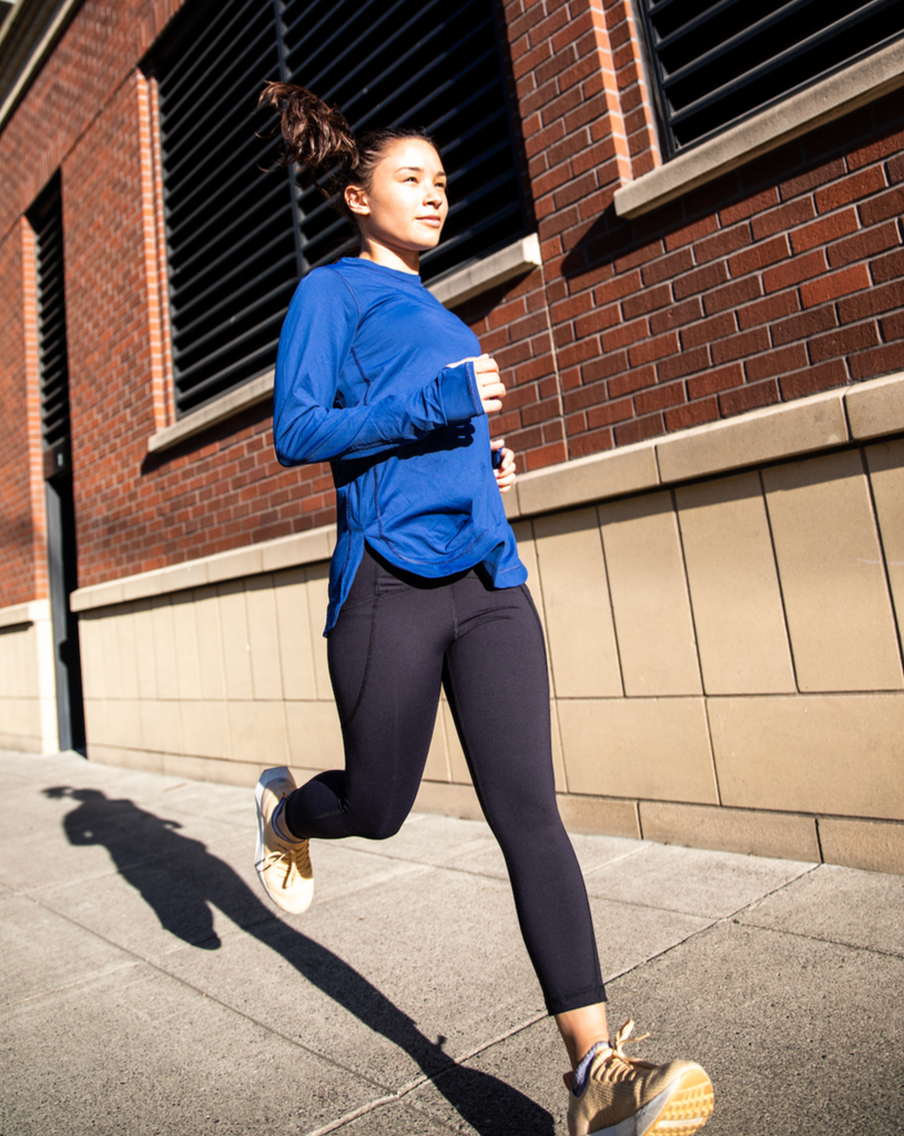 Women running in the city wearing relaxed navy scallop top. (Style 2015) - BloqUV