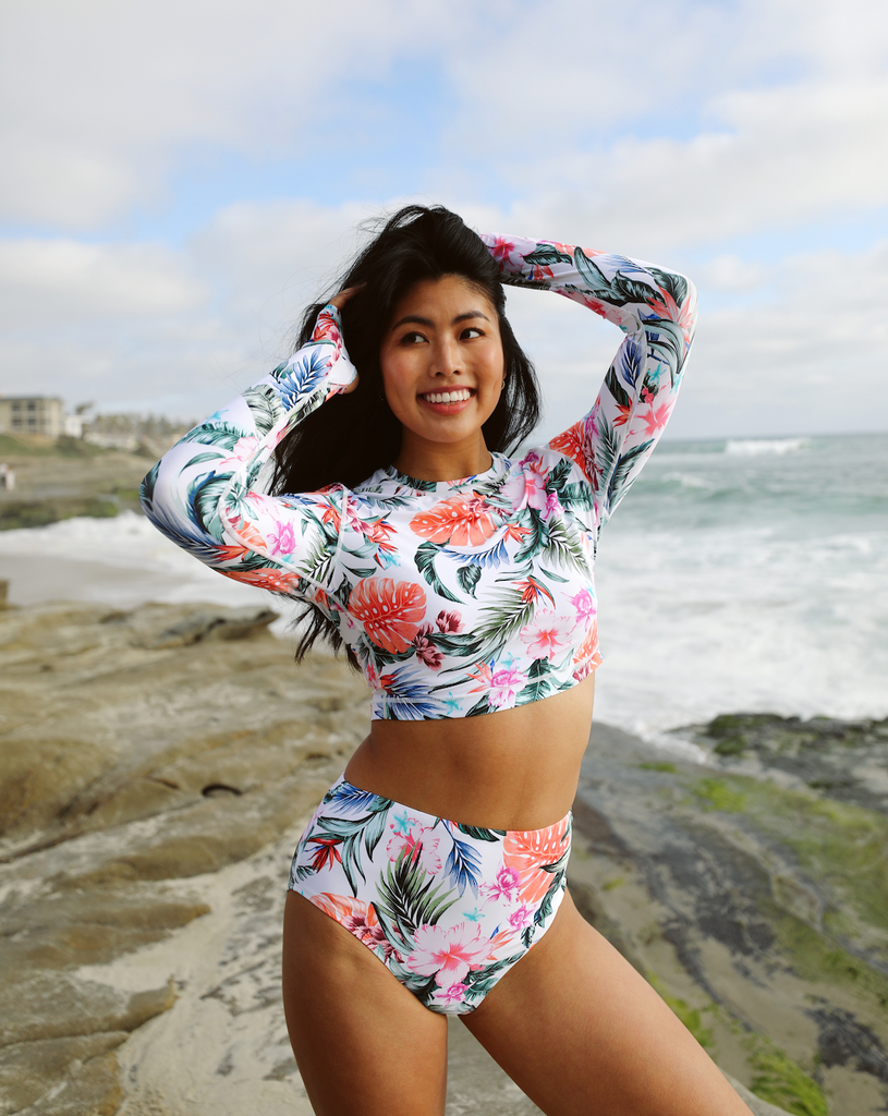Women at the beach wearing printed white top with Hawaiian print long sleeve everyday crop top with matching swimsuit bottom. (Style 4015J) - BloqUV