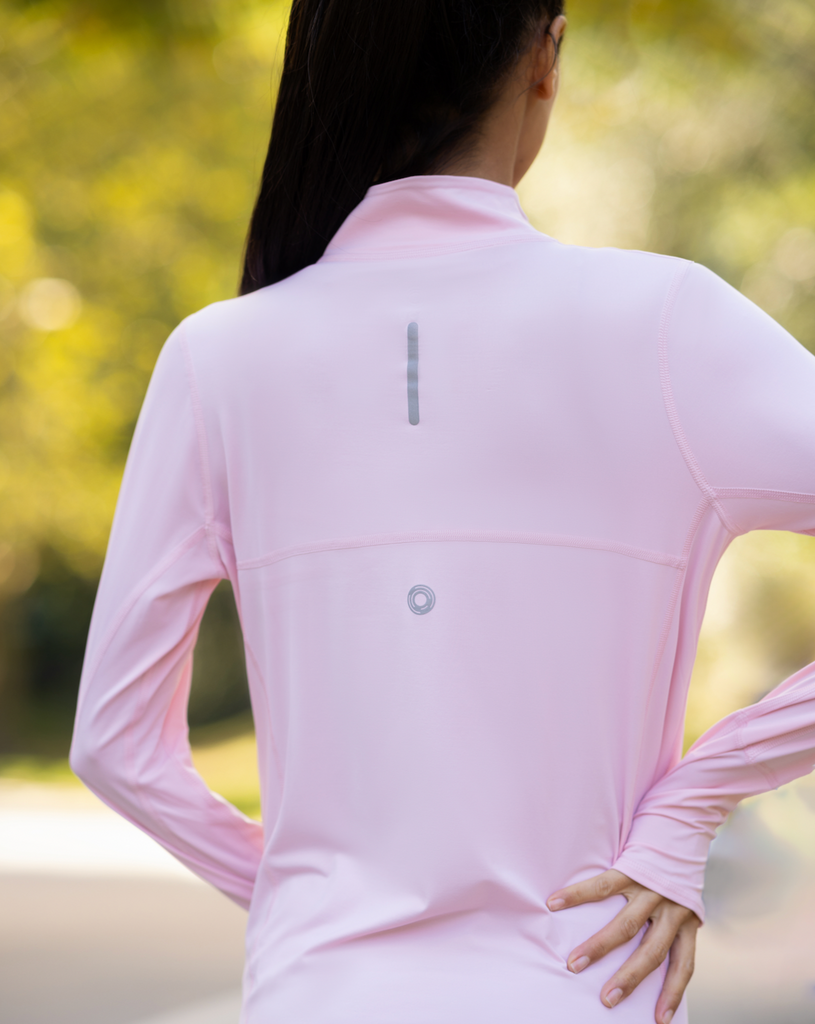 Women standing outside wearing tickle me pink relaxed mock zip top. Picture shows back of shirt. (Style 3002) - BloqUV